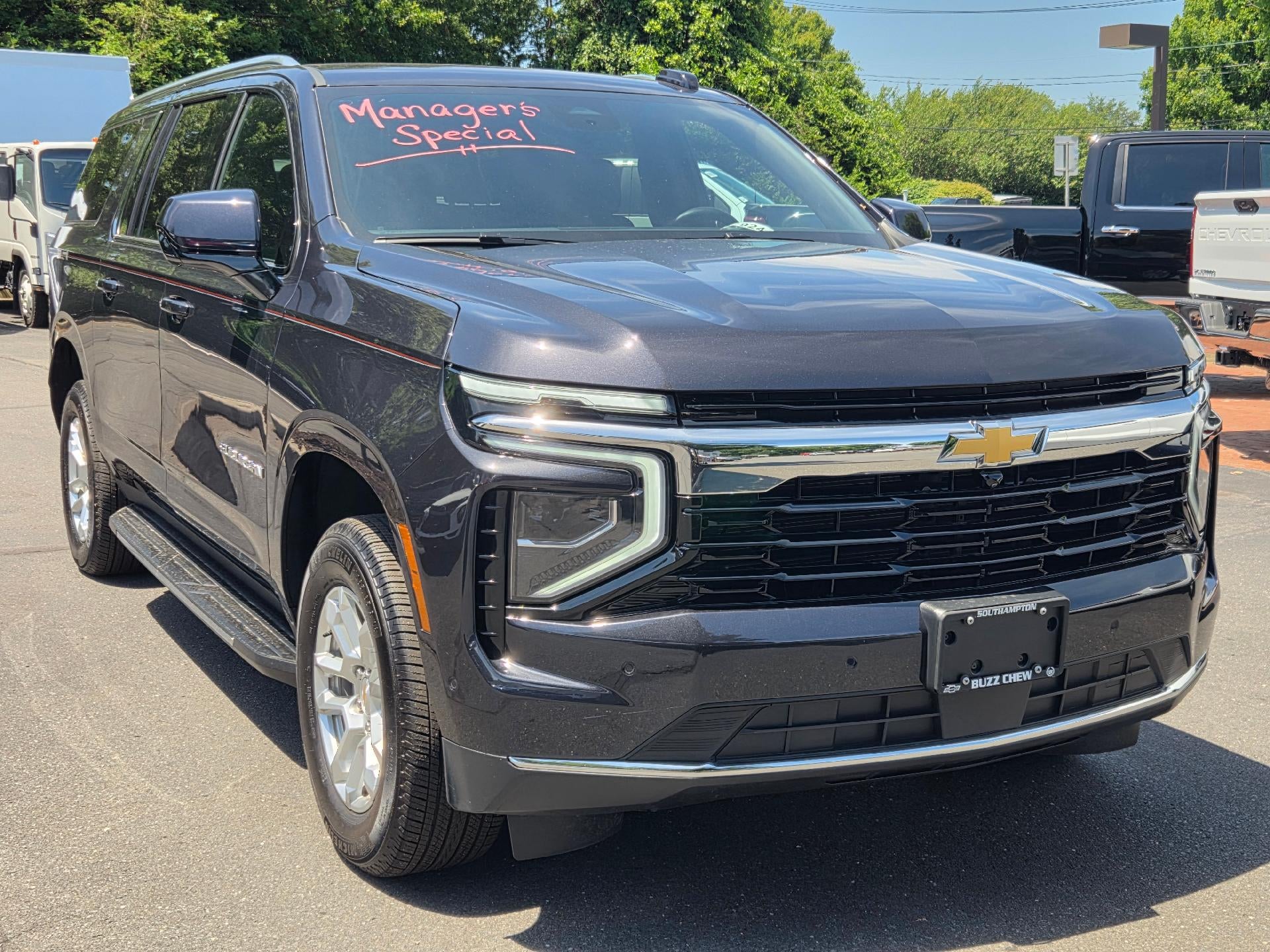 2025 Chevrolet Suburban LS in Dark Ash Metallic — front three-quarter view